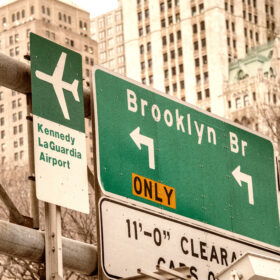 Brooklyn Bridge and Airports street signs in New York City.