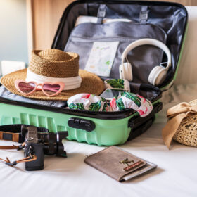 Traveler suitcase and luggage with travel accessories and items preparing for travel